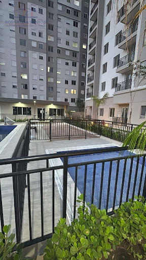 Piscina e entrada do prédio ao fundo